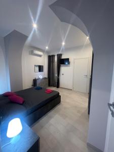 a bedroom with a bed and a room with a mirror at Guest House Villanova in Cagliari