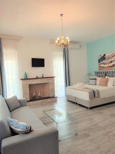 a living room with a couch and a fireplace at Thasos Blue Apartments in Prinos