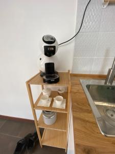 a coffee maker on a stand next to a sink at Happyhouse in Turin