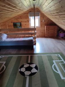 1 dormitorio con cama y pelota de fútbol en el suelo en Roztocze, Domek Na Leśnym Wzgórzu,Krasnobród,Zamość,Zwierzyniec, en Zamość