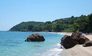 a beach with some rocks in the water at Sotiria Apartments in Kókkinon Nerón