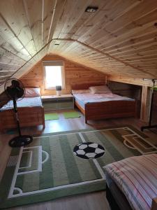 a room with two beds in a wooden cabin at Roztocze, Domek Na Leśnym Wzgórzu,Krasnobród,Zamość,Zwierzyniec in Zamość