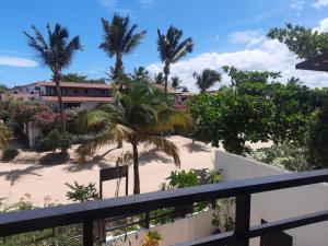 a view from the balcony of a resort with palm trees at Agapanthus Apartamentos in Jericoacoara