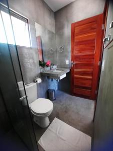 a bathroom with a toilet and a sink at Agapanthus Apartamentos in Jericoacoara +13 photos