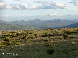 une vue sur un champ avec des montagnes en arrière-plan dans l'établissement Casa Rural Dunas, à Santa María de la Alameda