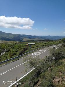 an empty road in the middle of a field at Casa Rural Dunas in Santa María de la Alameda