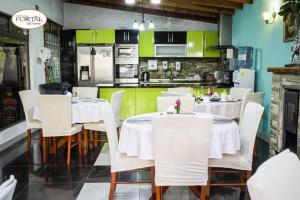 a dining room with white tables and white chairs at Hotel Portal del Norte in Copiapó