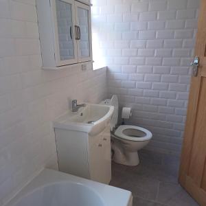 a white bathroom with a sink and a toilet at Lovely 2-Bed Apartment in Bridlington in Bridlington