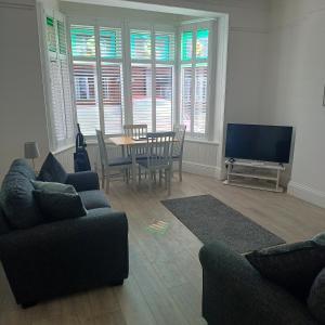 a living room with a table and chairs and a television at Lovely 2-Bed Apartment in Bridlington in Bridlington
