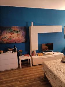 a bedroom with a bed and a blue wall at Colombo Holidays APT in Rome