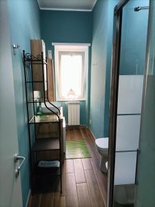 a bathroom with a toilet and a window at Colombo Holidays APT in Rome