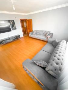 Il comprend un salon doté d'un canapé et d'une télévision à écran plat. dans l'établissement A family apartment in a quiet area, à Istanbul