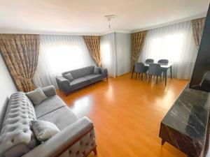 a living room with a couch and a table at A family apartment in a quiet area in Istanbul