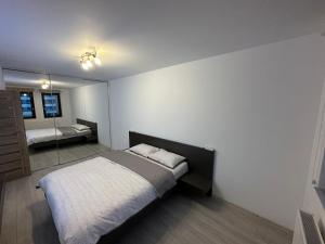 a bedroom with a bed and a mirror in it at BTA Apartment Park Lake in Cluj-Napoca