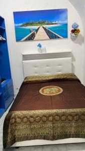 a bed in a room with a painting on the wall at Casa Vacanza Arcobaleno in Oria