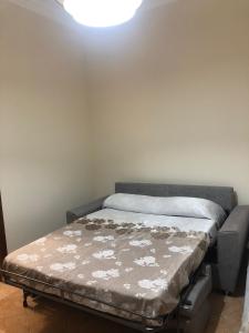 a bed in a room with a light on the ceiling at AM APARTAMENT in Palermo