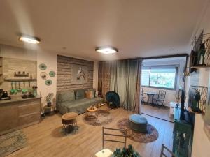 a living room with a couch and a table at Blue moon apartment in Eilat
