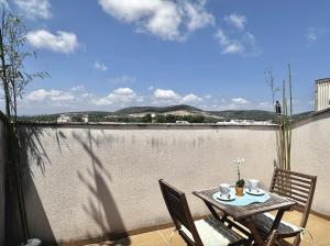 - une table sur un balcon avec vue sur l'eau dans l'établissement Ático dúplex con magnificas vistas, à Ulldecona