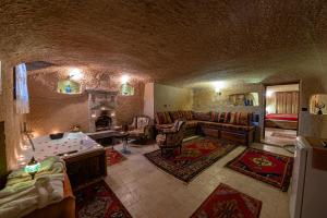 a large living room with a couch and a fireplace at Shiraz Cave Cappadocia in Urgup
