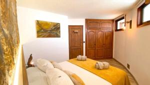 Postel nebo postele na pokoji v ubytování Bungalow Allende Famara con piscina privada y AC