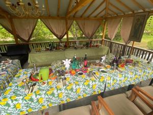 a table in a tent with a table cloth on it at Upmaļi in Eleja