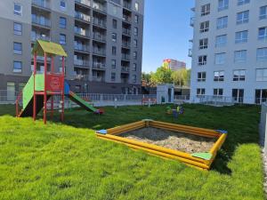 um parque infantil numa área relvada com equipamento de brincar em Apartament Koral - Kompozytorów Polskich 7 em Lublin