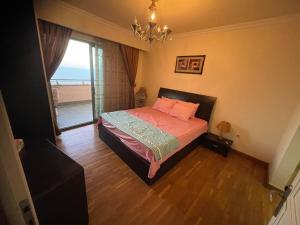 a bedroom with a bed with a view of the ocean at شقه فاخره - ابراج سان ستيفانو- جراند بلاز in Alexandria