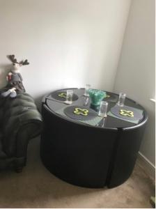 a black table with glasses on top of it at The Right Place. A Fabulous/Cozy Double Room in London