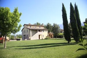 una casa en medio de un campo con árboles en Residenza Isabella, en Spello