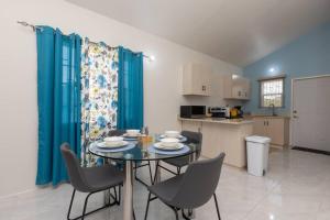 a dining room and kitchen with a table and chairs at Osmax Oasis entire house/2 bedrooms! in Discovery Bay