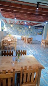 a large room with wooden tables and chairs at Ushguli Hotel Riho in Ushguli