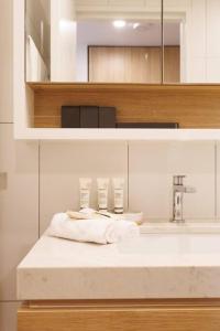 a bathroom with a sink and a counter with towels at Luxurious 2 Bed City Scape Retreat with Rooftop in Brisbane