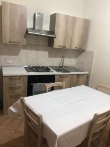 a kitchen with a table and a sink and a stove at AM APARTAMENT in Palermo