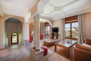 a living room with a couch and a table at Domaine Abiad in Marrakech