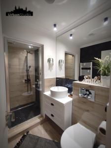 a bathroom with a toilet and a sink and a shower at Urban Studio - Self Check-in in Hunedoara