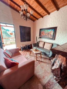 a living room with a couch and a fireplace at Las Orquídeas EcoHostel in Guarne