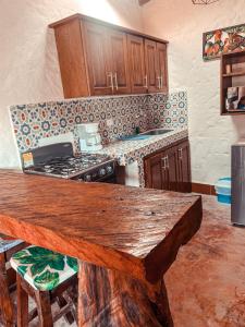 a kitchen with a wooden counter top and a stove at Las Orquídeas EcoHostel in Guarne