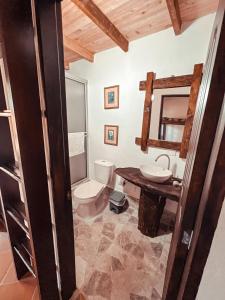 a bathroom with a toilet and a sink at Las Orquídeas EcoHostel in Guarne +49 photos