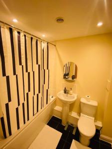 a bathroom with a toilet and a sink at Beautiful and Modern 2 bedroom flat in Colindale in Colindale