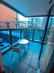 a patio with a table and chairs on a balcony at Beautiful and Modern 2 bedroom flat in Colindale in Colindale