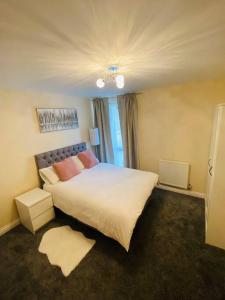 a bedroom with a large white bed and a window at Beautiful and Modern 2 bedroom flat in Colindale in Colindale