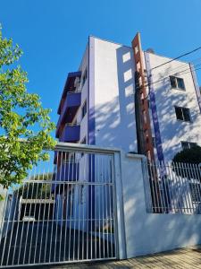 a building with a gate in front of it at Apartamento com mobília nova 101! in Francisco Beltrão