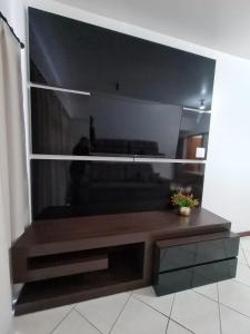 a living room with a large flat screen tv at Apartamento com mobília nova 101! in Francisco Beltrão