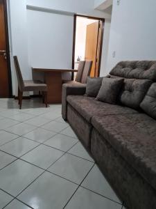 a living room with a couch and a table at Apartamento com mobília nova 101! in Francisco Beltrão