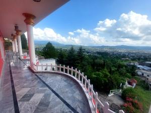 a balcony of a building with a bridge over a river at RED ROSE HOTEL & RESORT Mansehra in Mānsehra