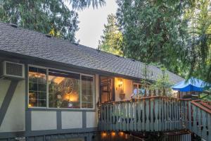 una casa con un porche con una valla en Cozy Bird house w Big screen!, en Mount Hood Village