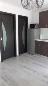 a kitchen with two sliding doors in a room at Apartmani HERMES Jadrija in Šibenik
