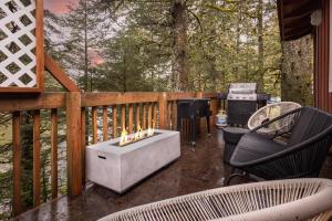 a fire pit on a deck with a grill at THE SHORELINE CABIN in Kodiak