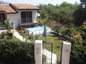 a house with a swimming pool in a yard at La Rosa dell'Etna in Castiglione di Sicilia