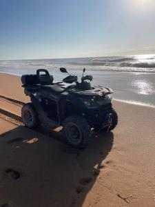 a atv parked on the beach near the ocean at Villa La Falaise in Oualidia